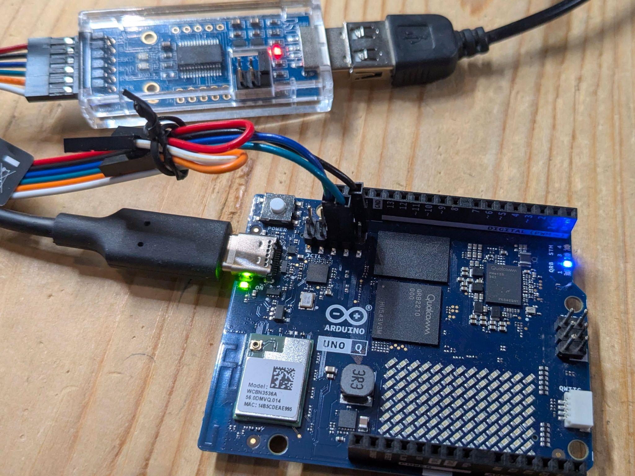 SH-U09C2 USB-to-TTL adapter connected to the UNO Q JCTL header with three jumper wires
